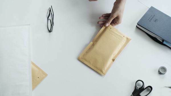 woman using packing bubble envelope brown